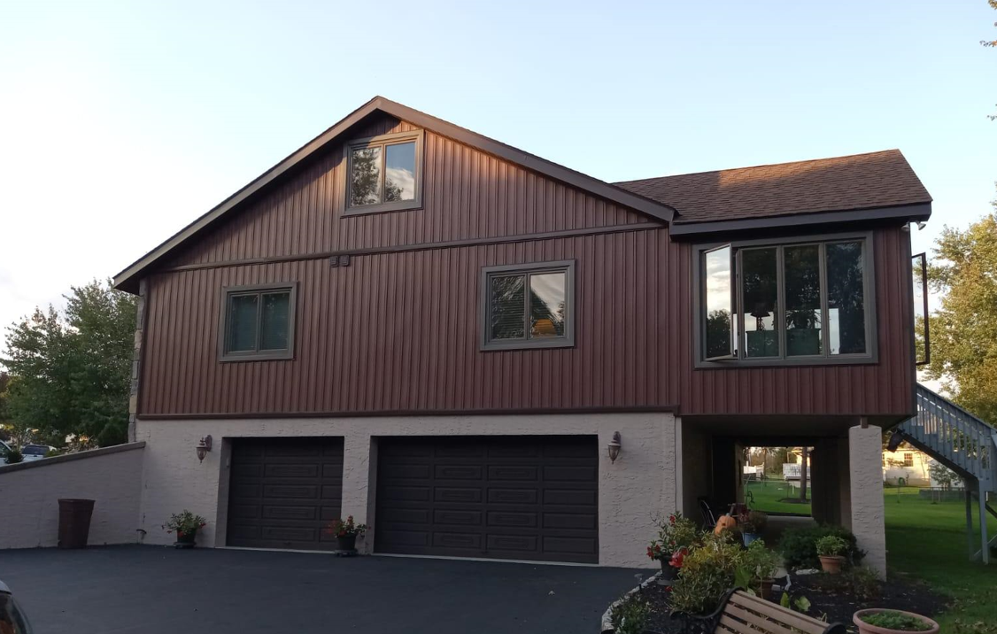 A large house with two garage doors and a staircase