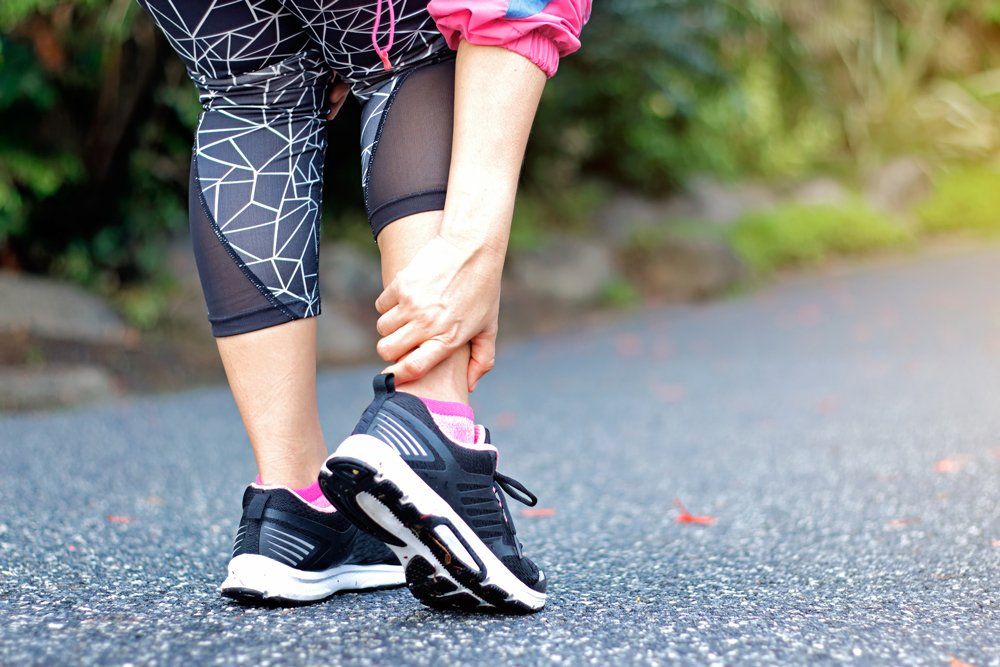 Massaging Ankle Before Jogging — Tavernier, FL — Garrett Chiropractic & Wellness Center