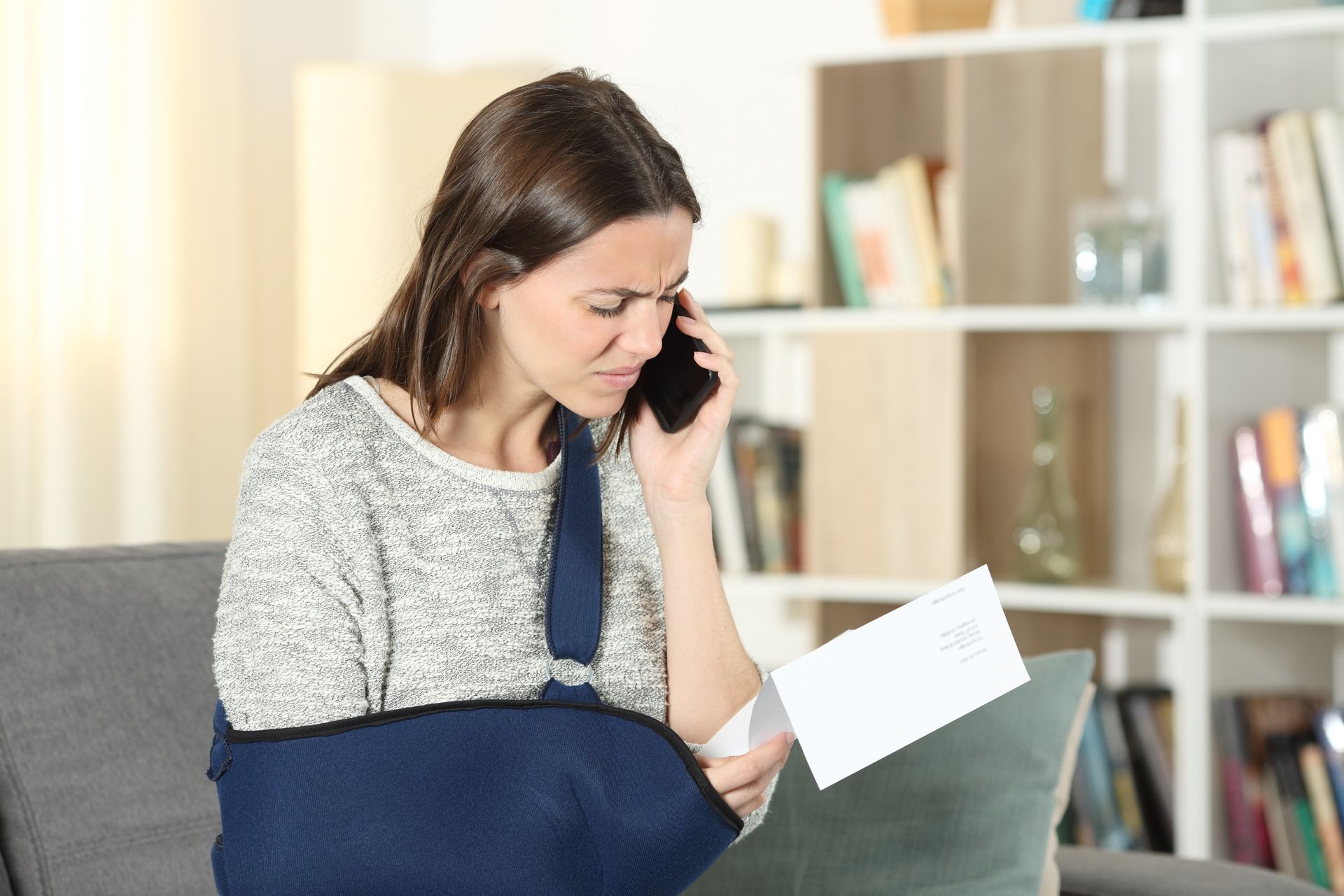 A disabled woman claiming an insurance claim on a mobile phone.