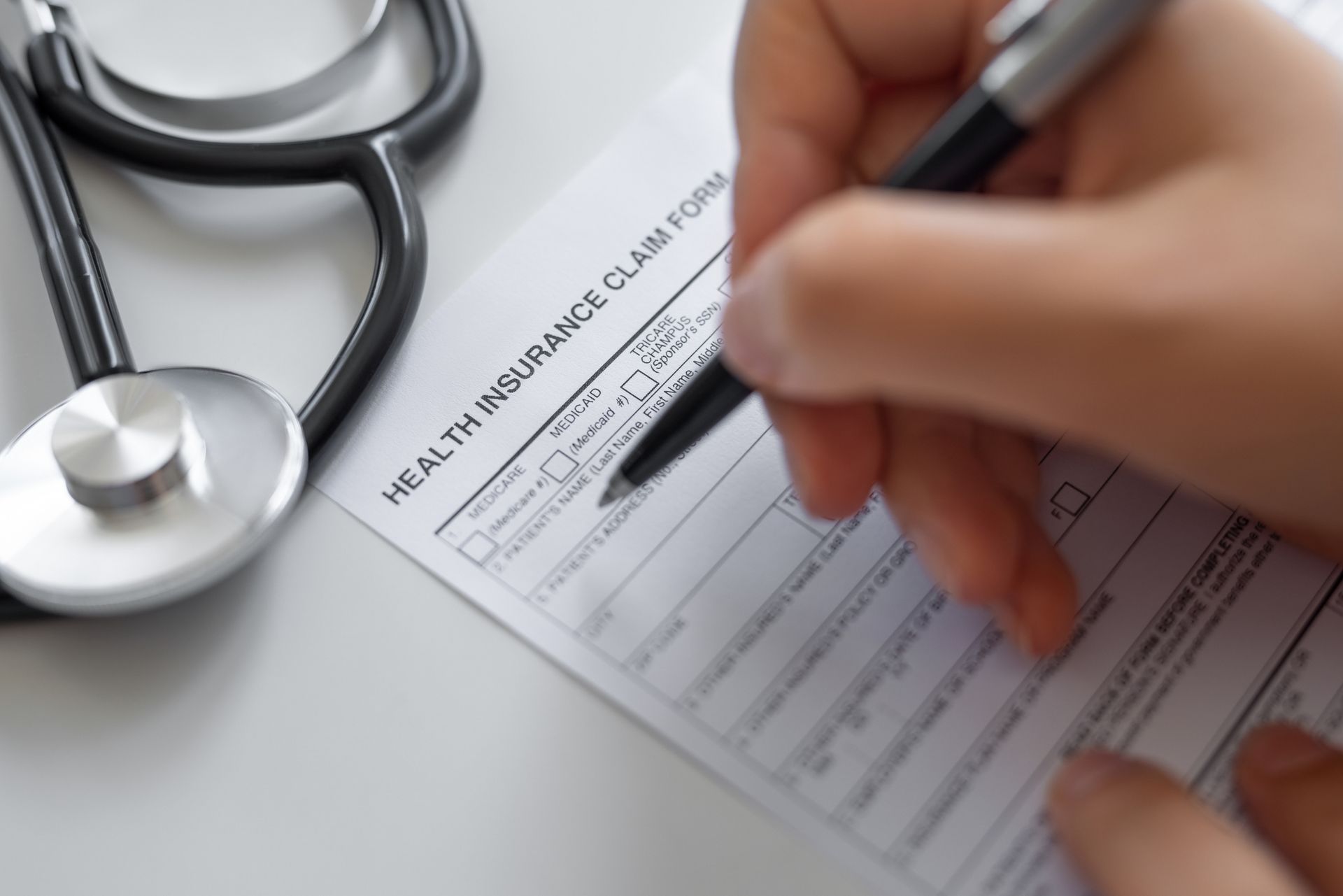 Woman filling health insurance appeal process form.