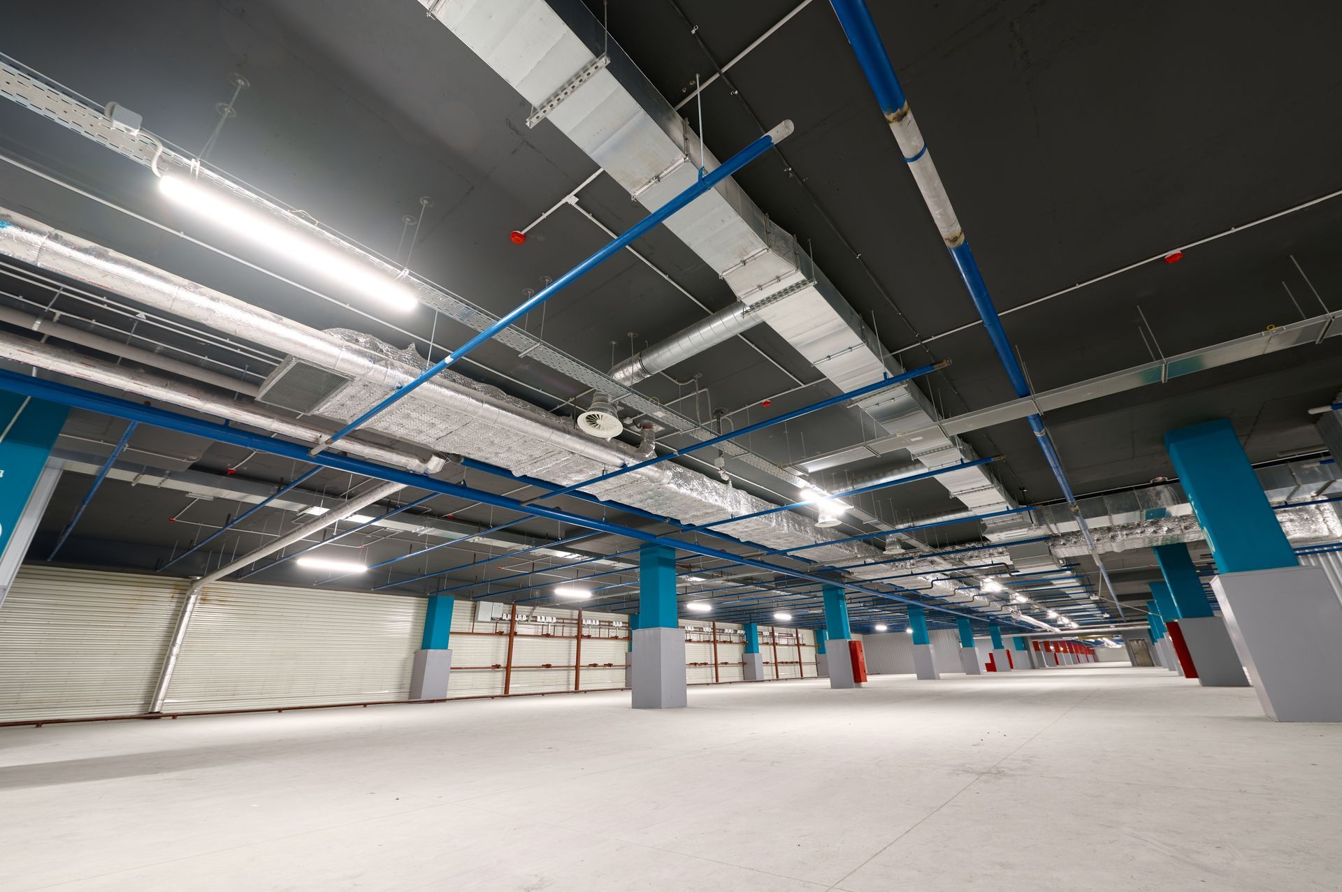 Spacious underground car park with modern lighting and wide open areas for vehicles.