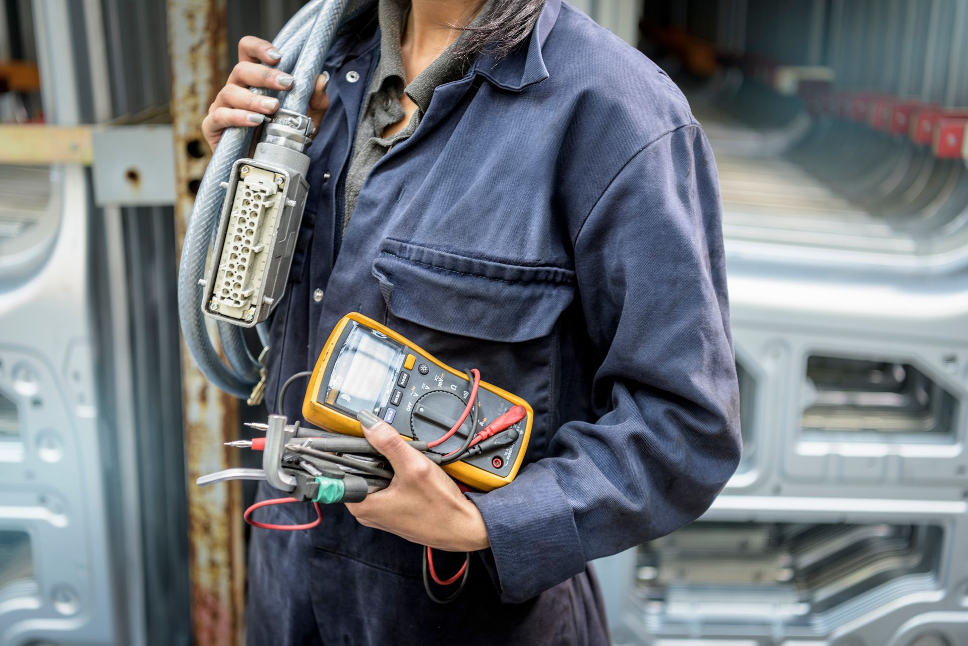 An electrician holding electrical equipment. An electrician holding electrical equipment.
