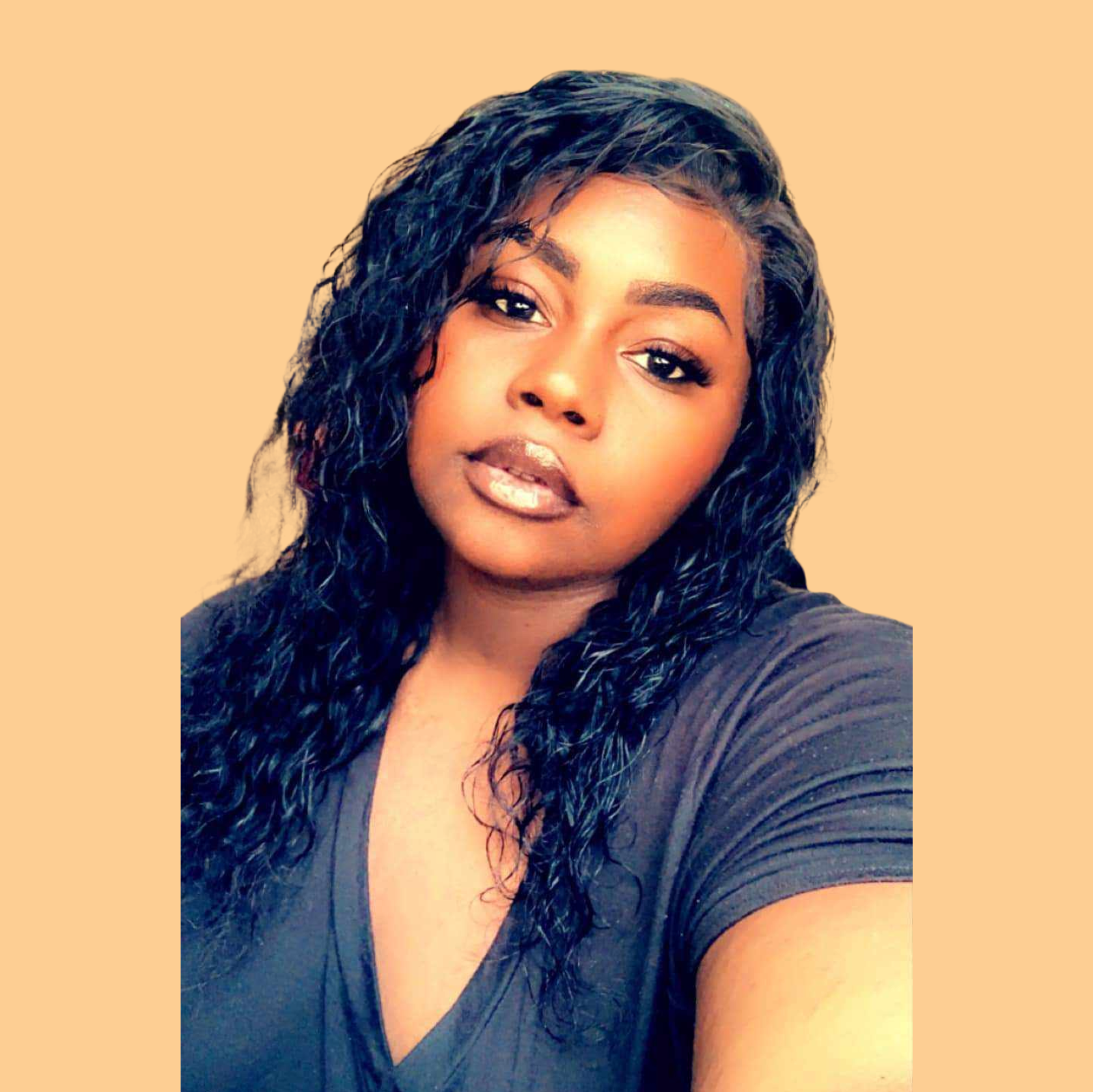 A woman with curly hair is taking a selfie.
