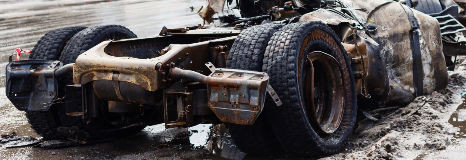 a muddy, totaled truck is sitting on the side of the road -- this truck is not responsible for theft or fraud