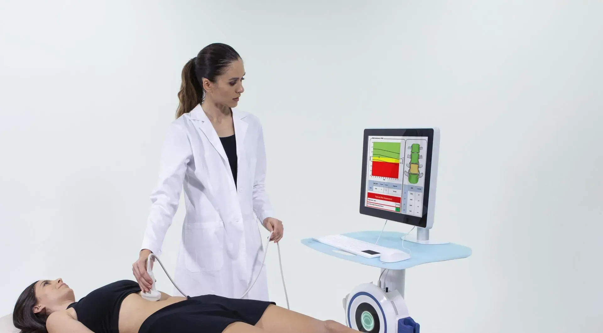 A doctor is examining a woman 's stomach with a machine.