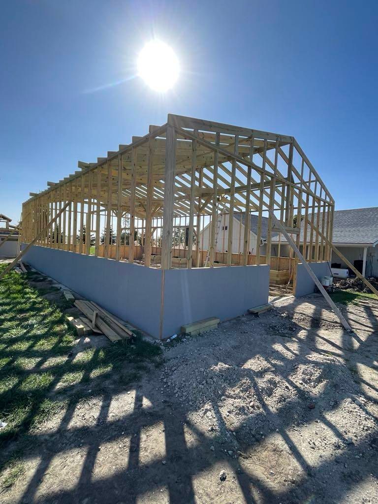 Partially framed house under construction on a sunny day