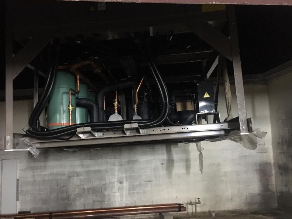 A Room With a Lot of Pipes Hanging From the Ceiling — Legit Air Conditioning & Refrigeration in Garbutt, QLD