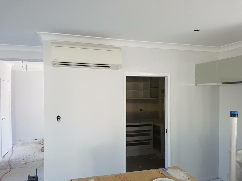 A Room With White Walls and a Door Leading to a Kitchen — Legit Air Conditioning & Refrigeration in Garbutt, QLD