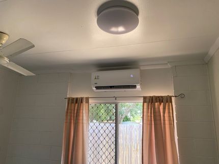 A Room With a Window , Ceiling Fan , and Air Conditioner — Legit Air Conditioning & Refrigeration in Garbutt, QLD