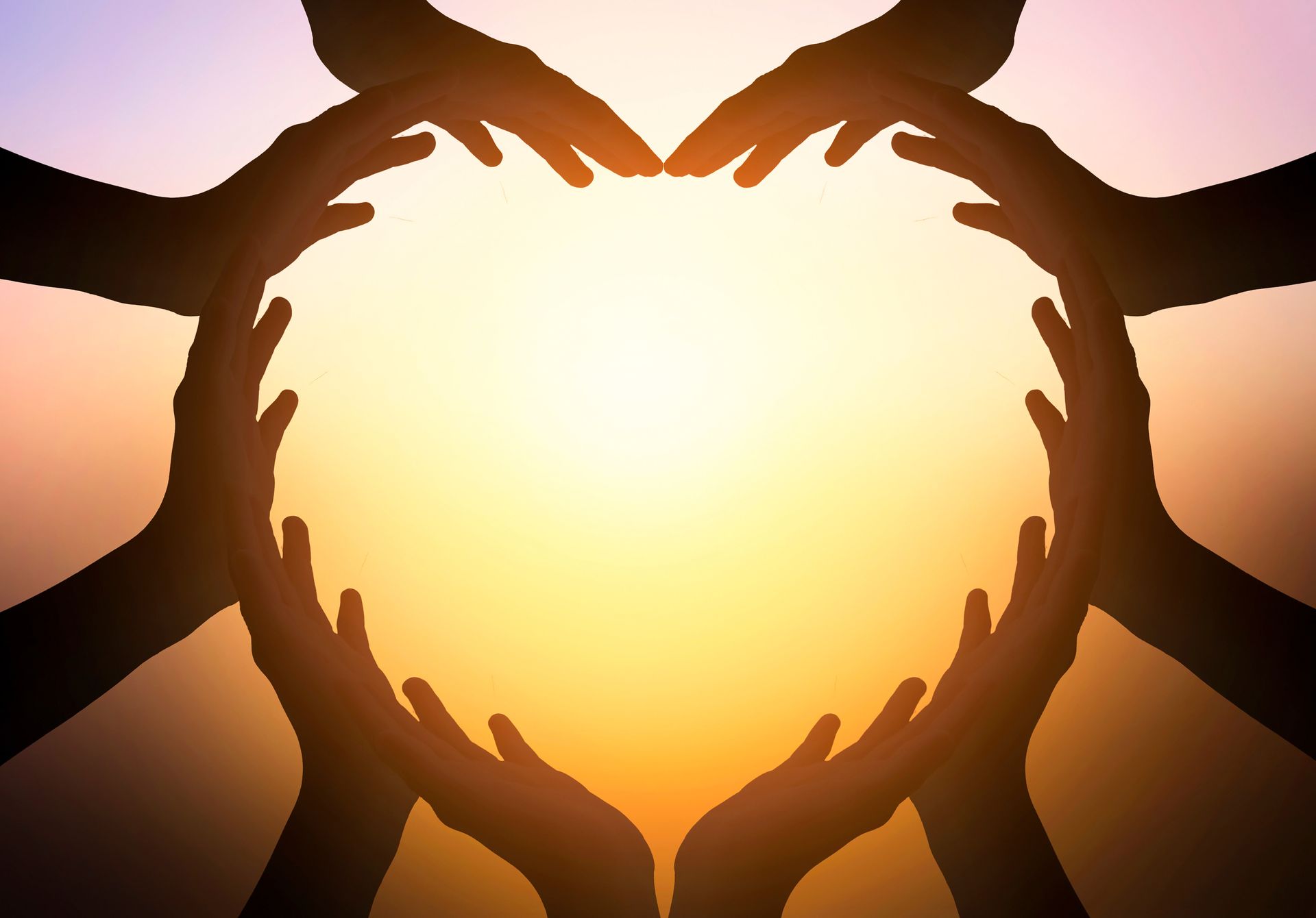 Hands of different people forming a heart