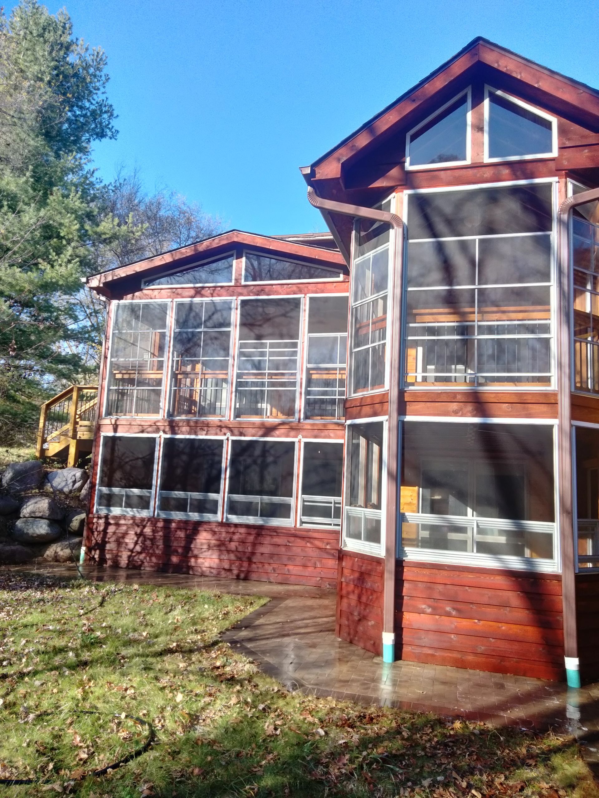 A large house with lots of windows and a screened in porch