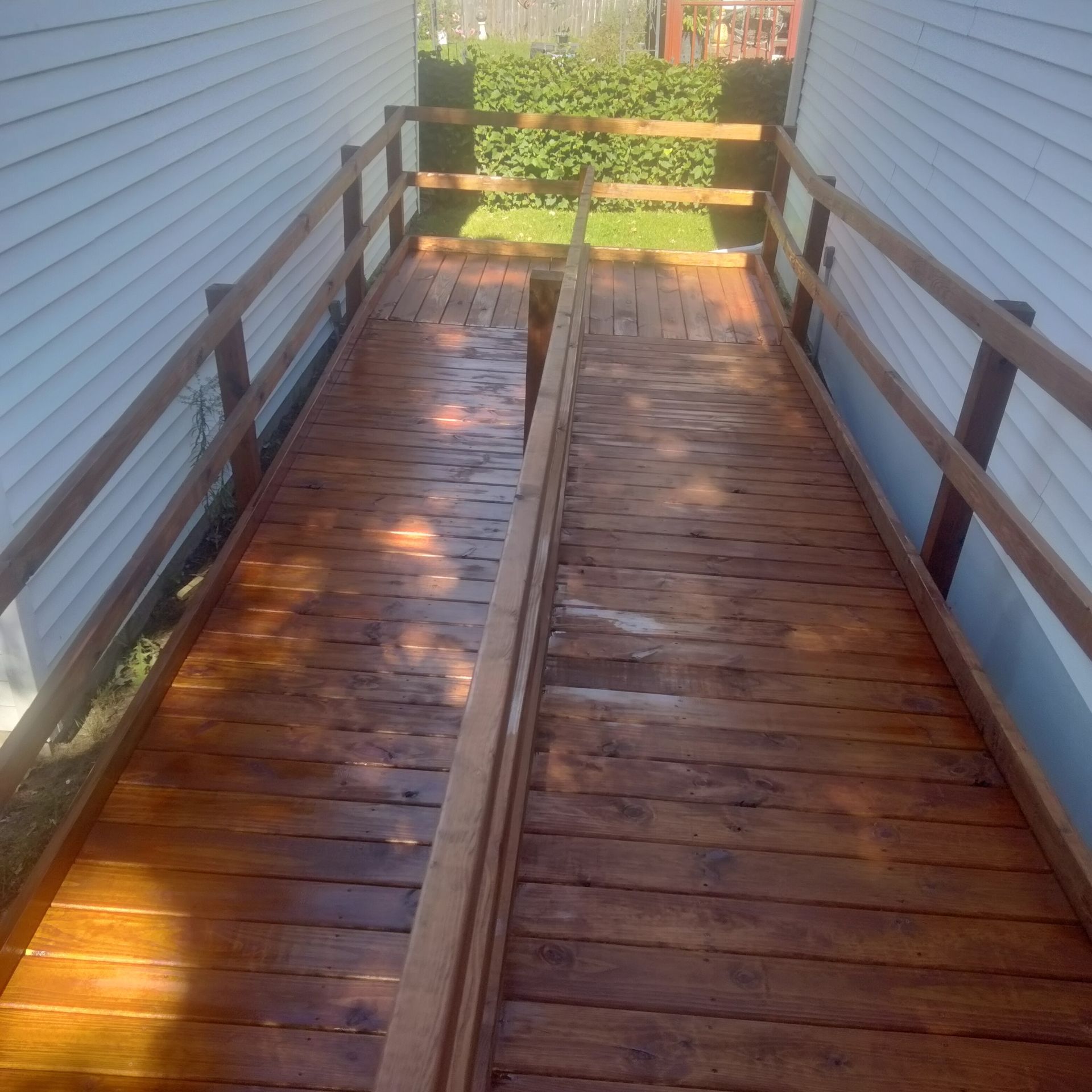 A wooden ramp leading to a white house