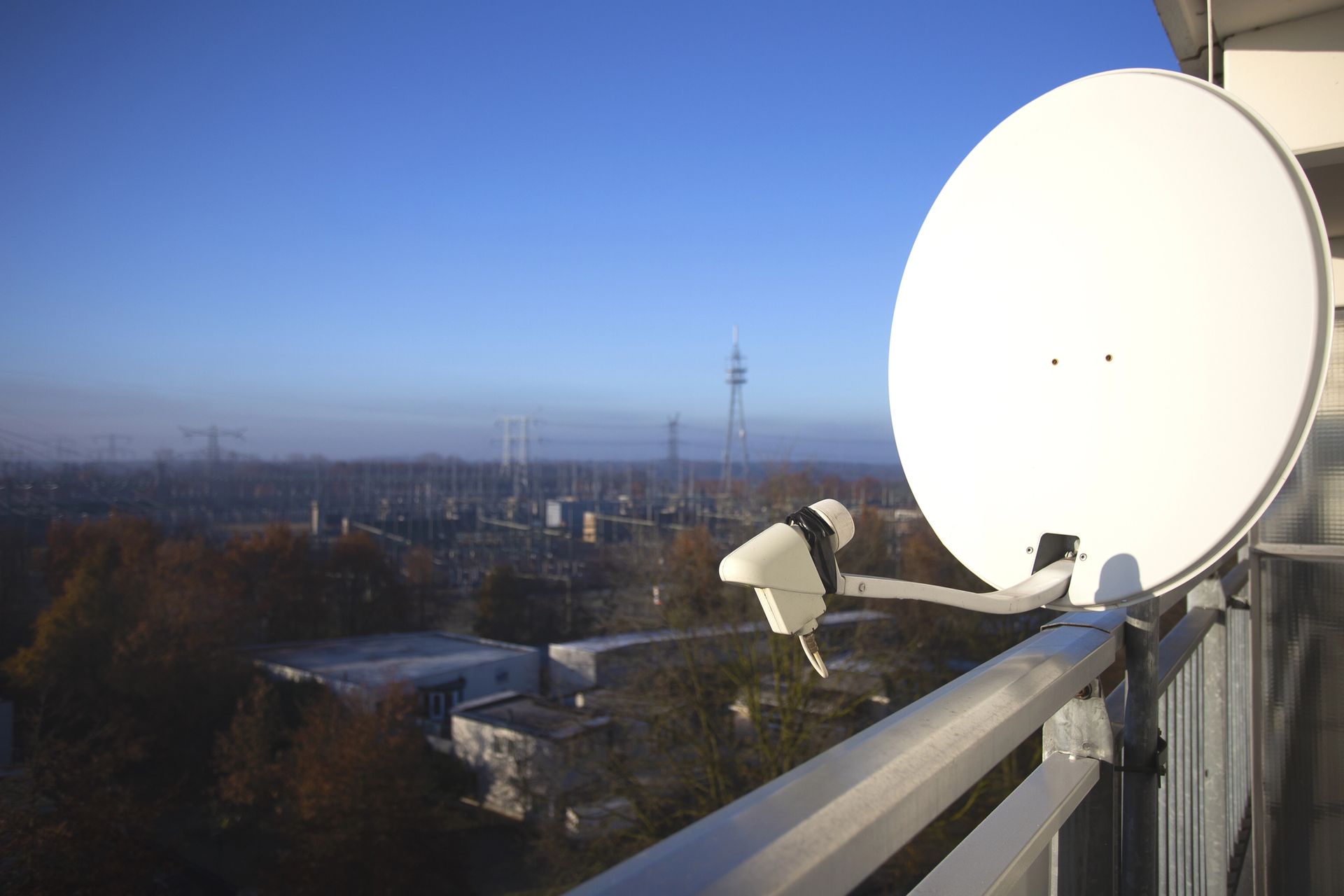 Antenna parabolica sul tetto affacciata sullo skyline della città al tramonto