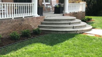Clean green fertilized lawn services with sharp edges and landscaping elements