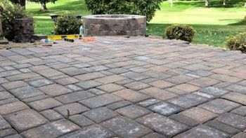 Beautiful Patio pavers installed locally leading up to a custom matching masonry fire pit