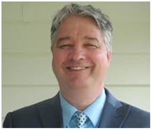 A man in a suit and tie is smiling for the camera. Jack Krutzen