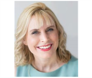 A woman with blonde hair is smiling and wearing a blue shirt. Julia Shallcrass