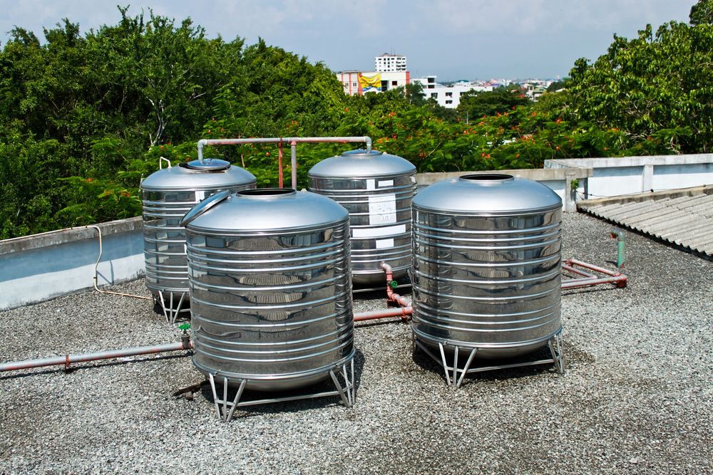 A Group Of Stainless Steel Water Tanks — Nudges Plumbing In Nyngan, NSW