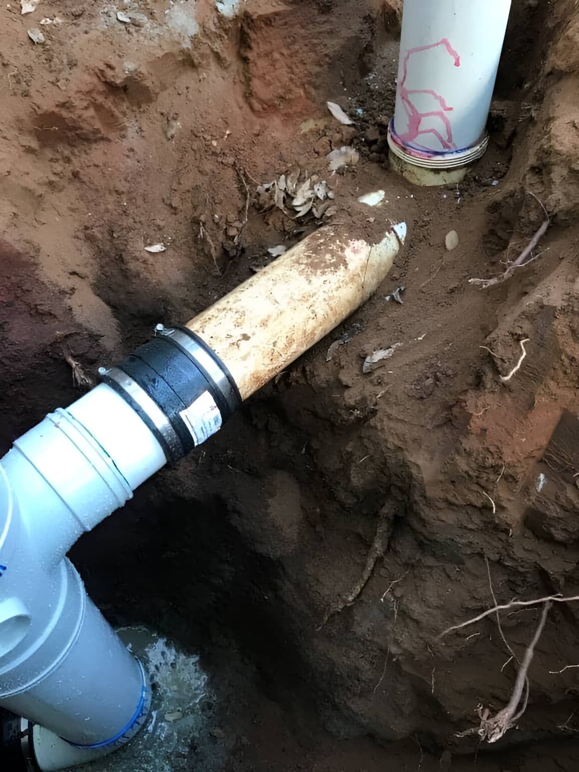 A Pipe Is Being Installed In A Hole In The Ground — Nudges Plumbing In Dubbo, NSW