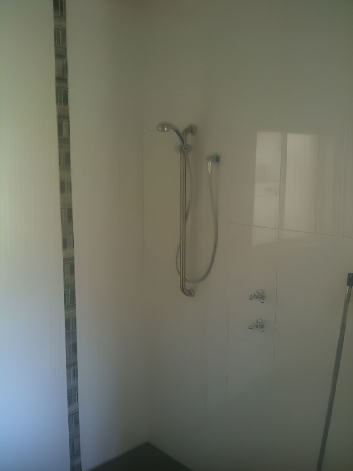 A Bathroom With White Tiles And A Shower Head — Nudges Plumbing In Dubbo, NSW