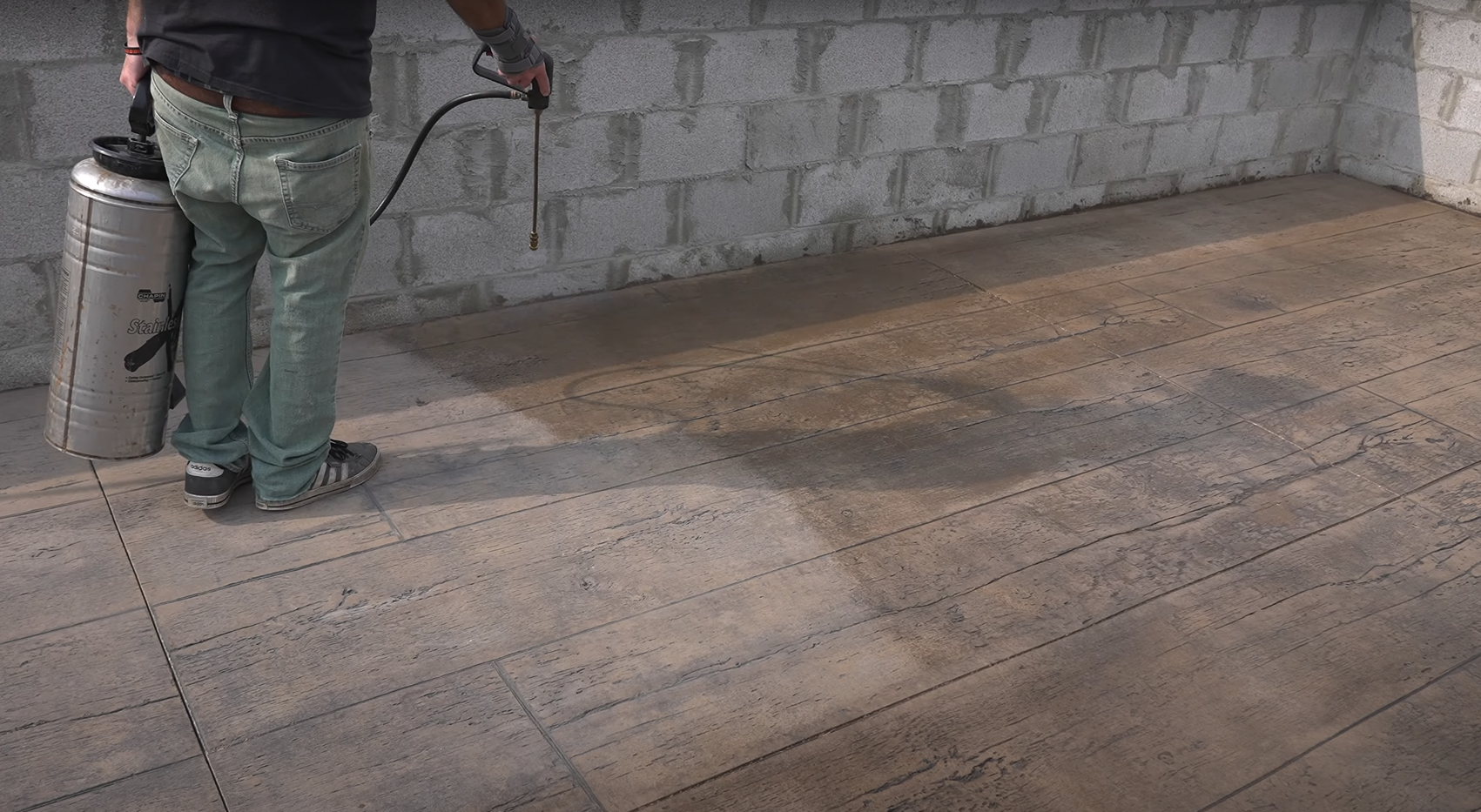 concrete contractor sealing a stamped concrete design