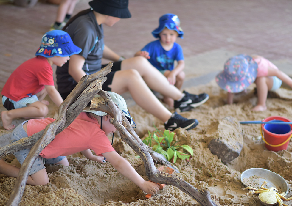 A group of children are playing in a sandbox.