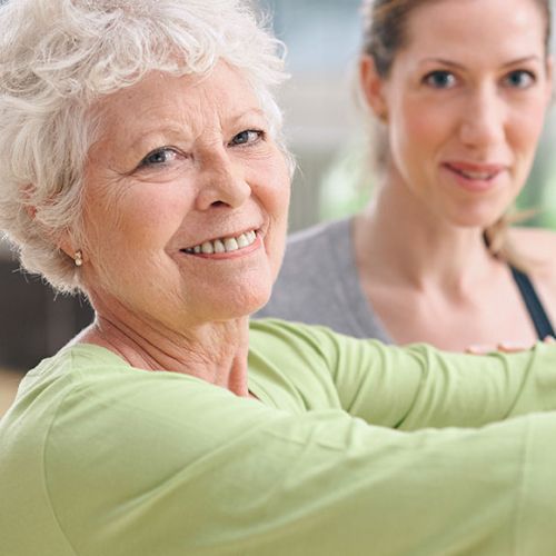 An older woman and a younger woman are smiling for the camera.