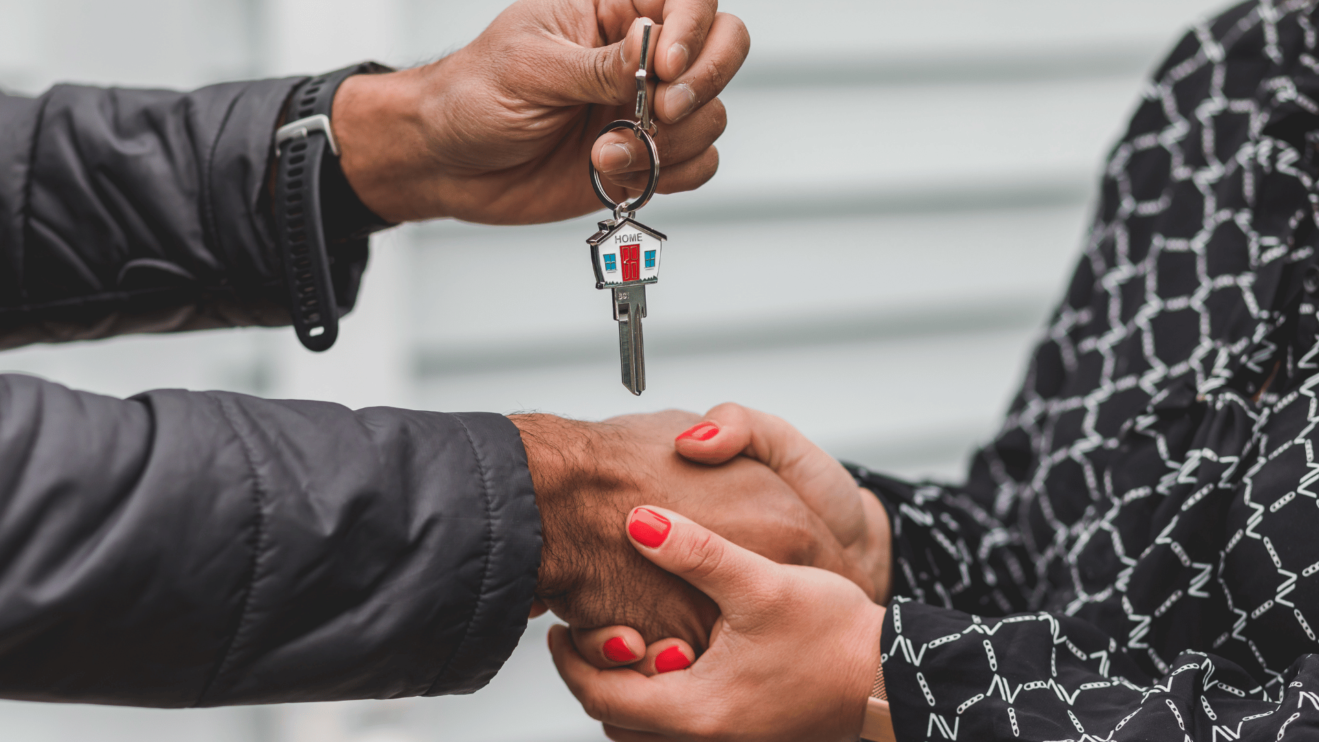 Close-up of a smooth handover of two sets of house keys, a weathered set and a modern silver set, against a blurred. Detailed close-up of a fresh handover of two different sets of house keys after avoiding foreclosure.