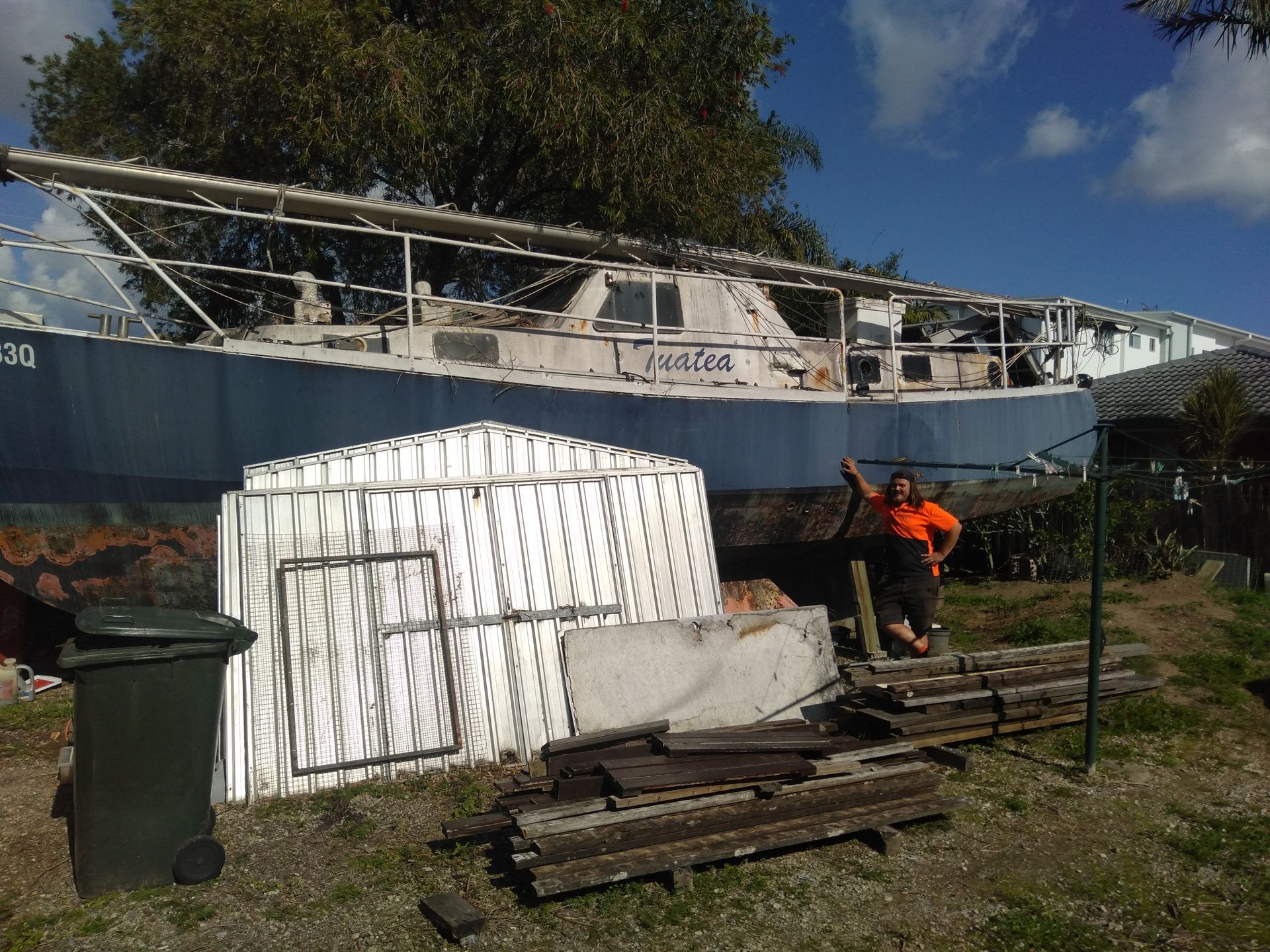 A Man Standing In Front Of A Boat — Tweed Byron Recycling In Tweed Heads, NSW