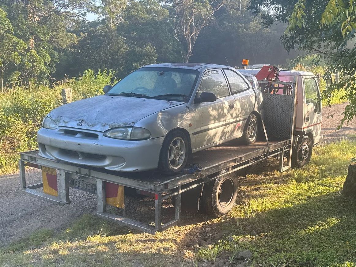 A Silver Car Is Sitting On Top Of A Tow Truck — Tweed Byron Recycling In Tweed Heads, NSW