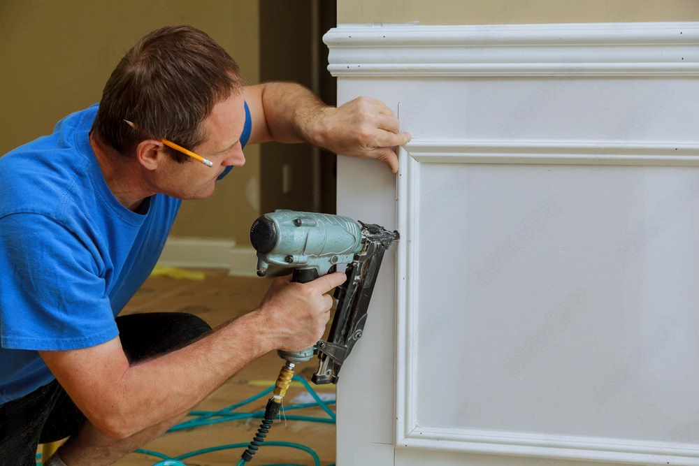 A man working with wood wallings.