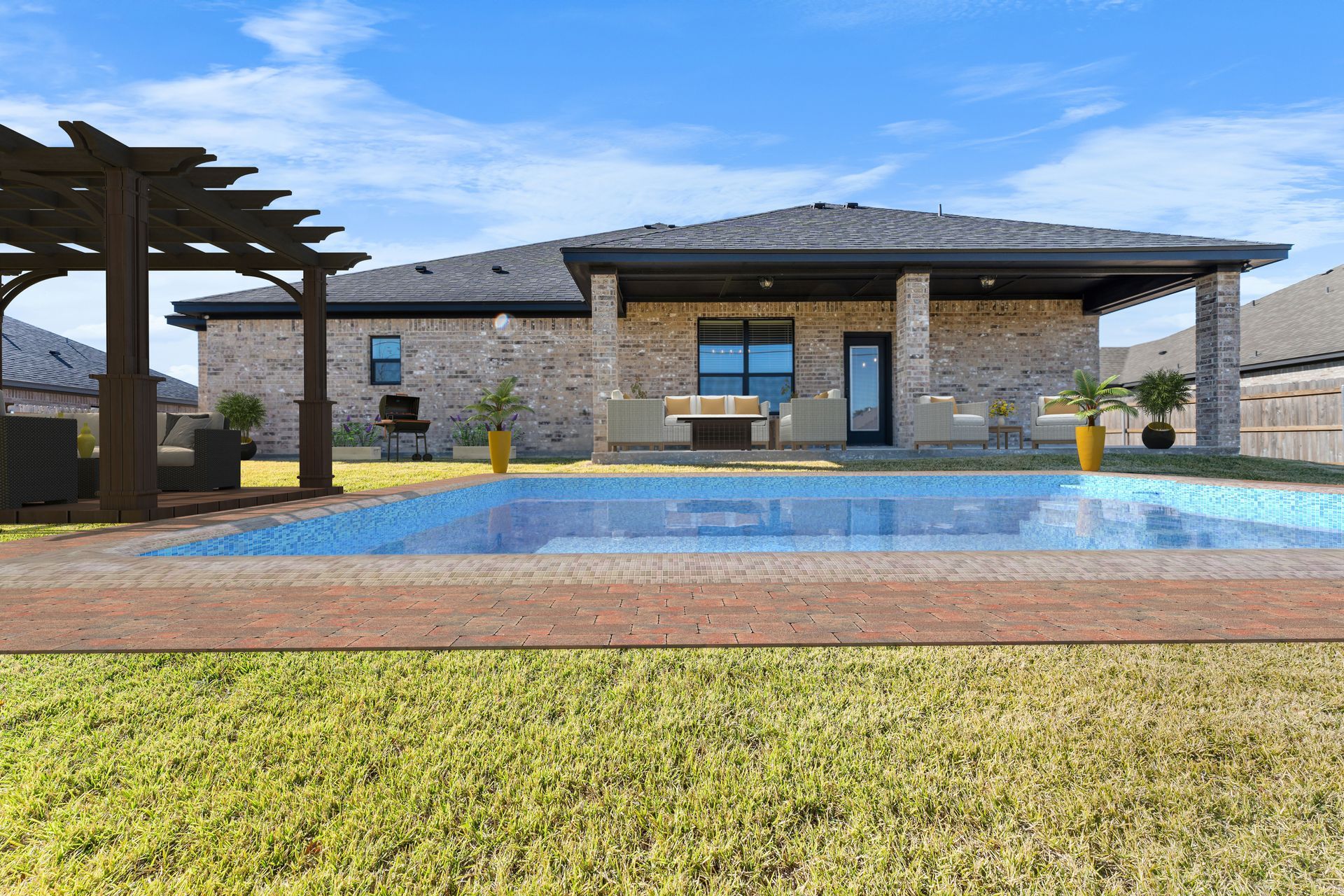 Backyard with a swimming pool, patio, and brick house under a blue sky.