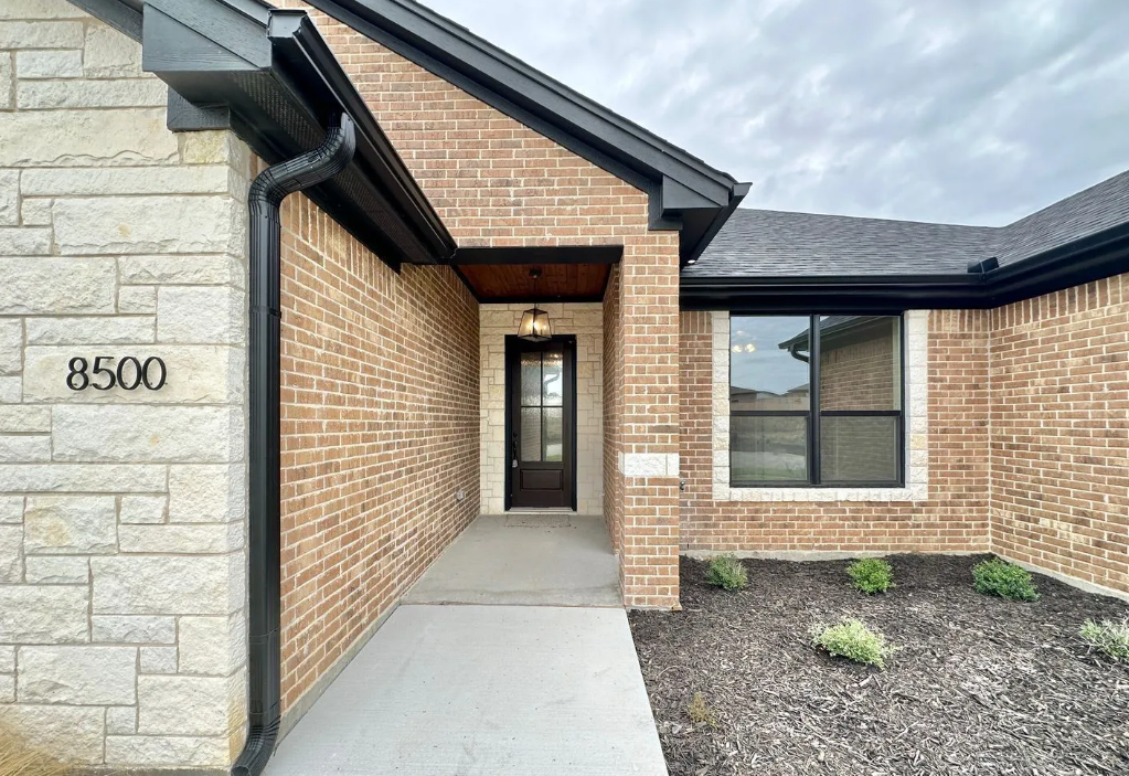 Entrance to a brick house with address 