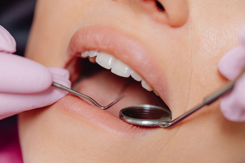Professionista odontoiatrico durante una visita gengivale in uno studio moderno