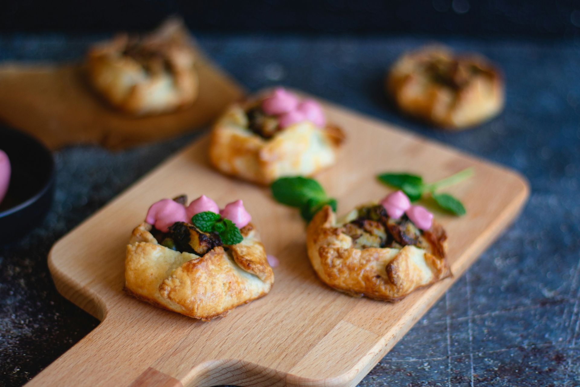 Savory pastry appetizers on wooden board