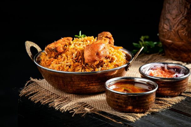 Chicken biryani with raita and gravy