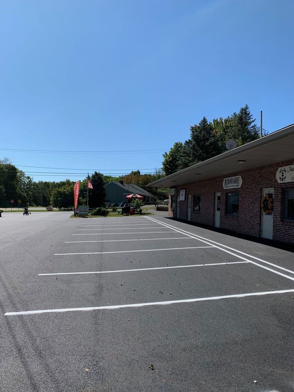 Exterior shot of a business complex with a newly paved parking lot on a sunny day.