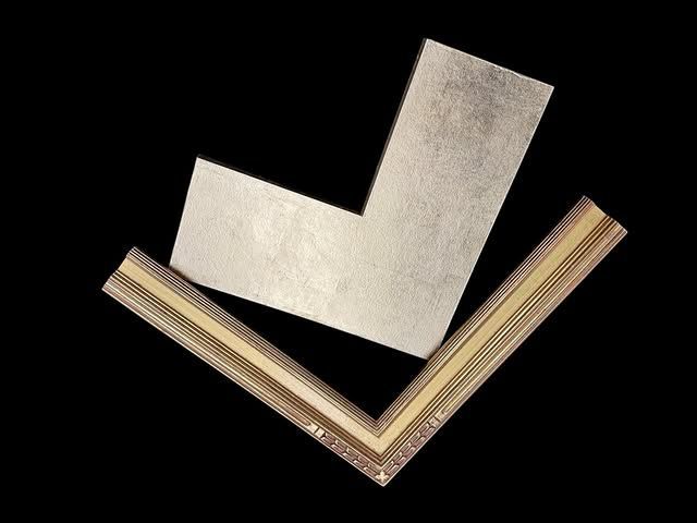 Two corner samples of decorative picture frames, one metallic silver and one with textured gold and dark brown details.