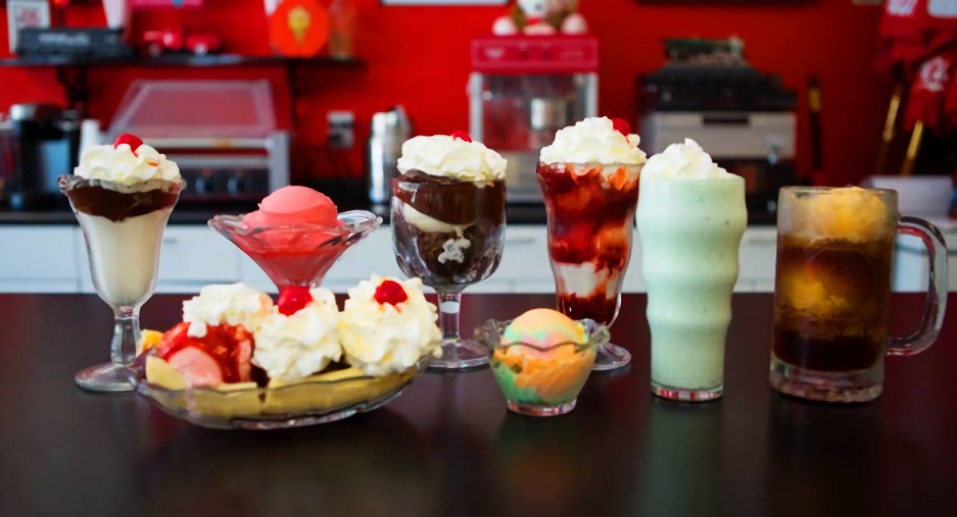 A table topped with a variety of desserts and drinks.