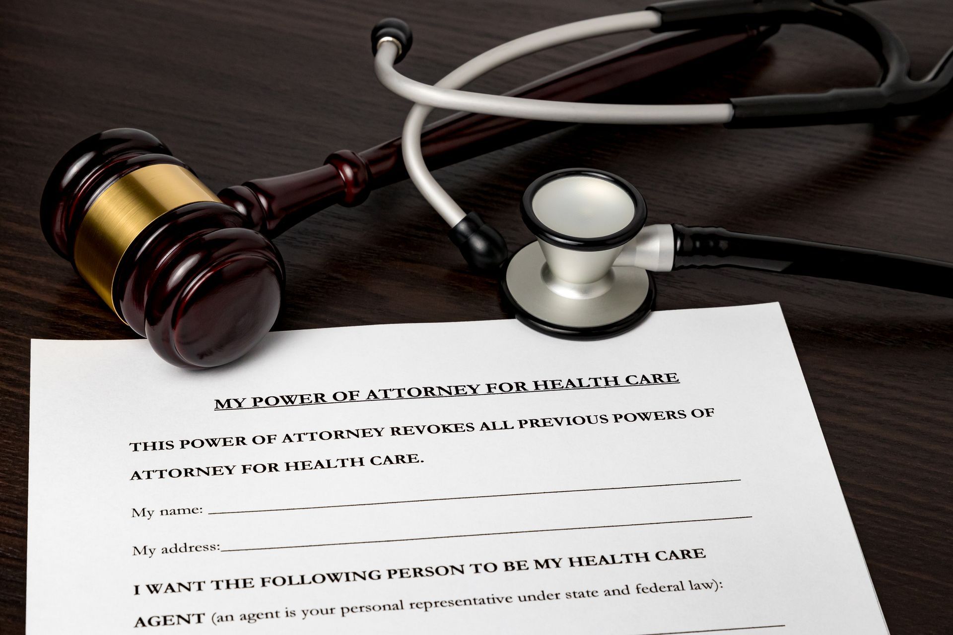 Power of Attorney for health care, HCPA, with gavel and stethoscope. Concept of planning for death, final wishes, terminal illness, and advance directive.