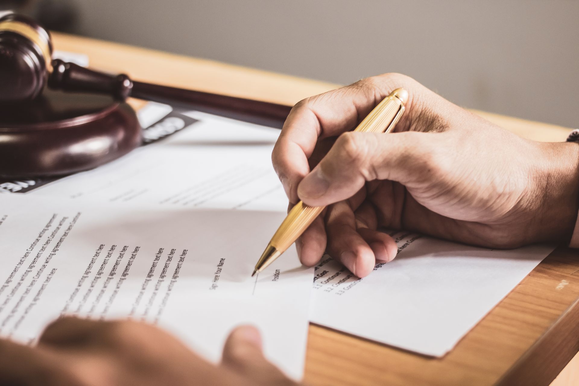 businessman or lawyers sitting office signing contract papers on wood table. Law of advisor Concepts and vintage, Sunset light.Selective Focus.