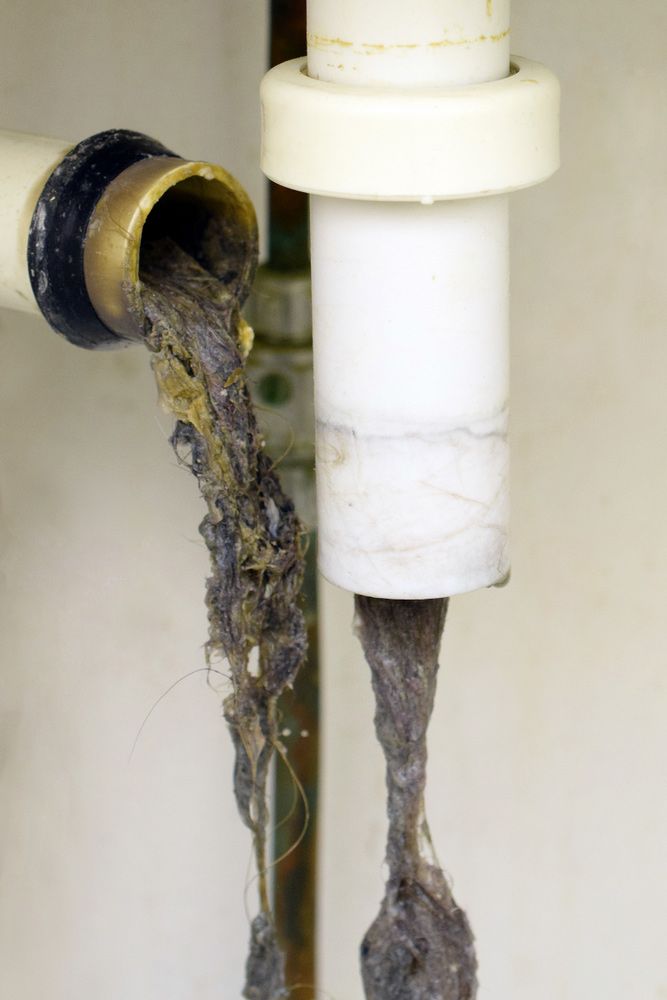 A Close Up of a Drain Pipe With a Lot of Dirty Water Coming Out of It — All Plumb & Gas in North Boambee Valley, NSW