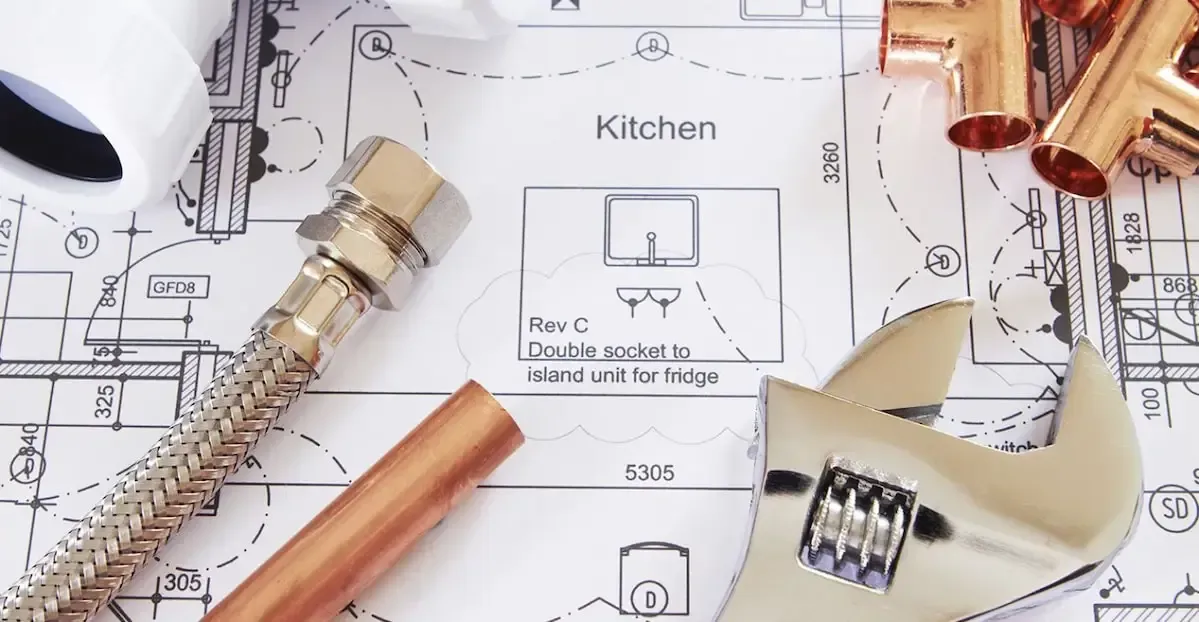 Copper Pipes and a Wrench on Top of a Kitchen Drawing — All Plumb & Gas in North Boambee Valley, NSW