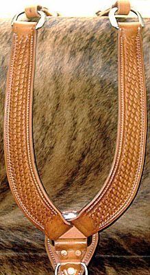 Brown tooled leather breast collar with silver hardware.