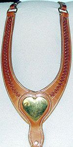 Leather horse breast collar with a gold heart-shaped plate, stitched design, and brown straps.