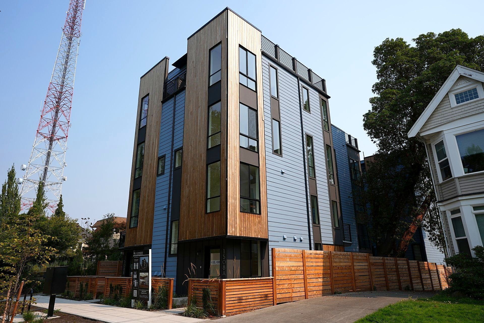 A large building with a lot of windows and a wooden fence