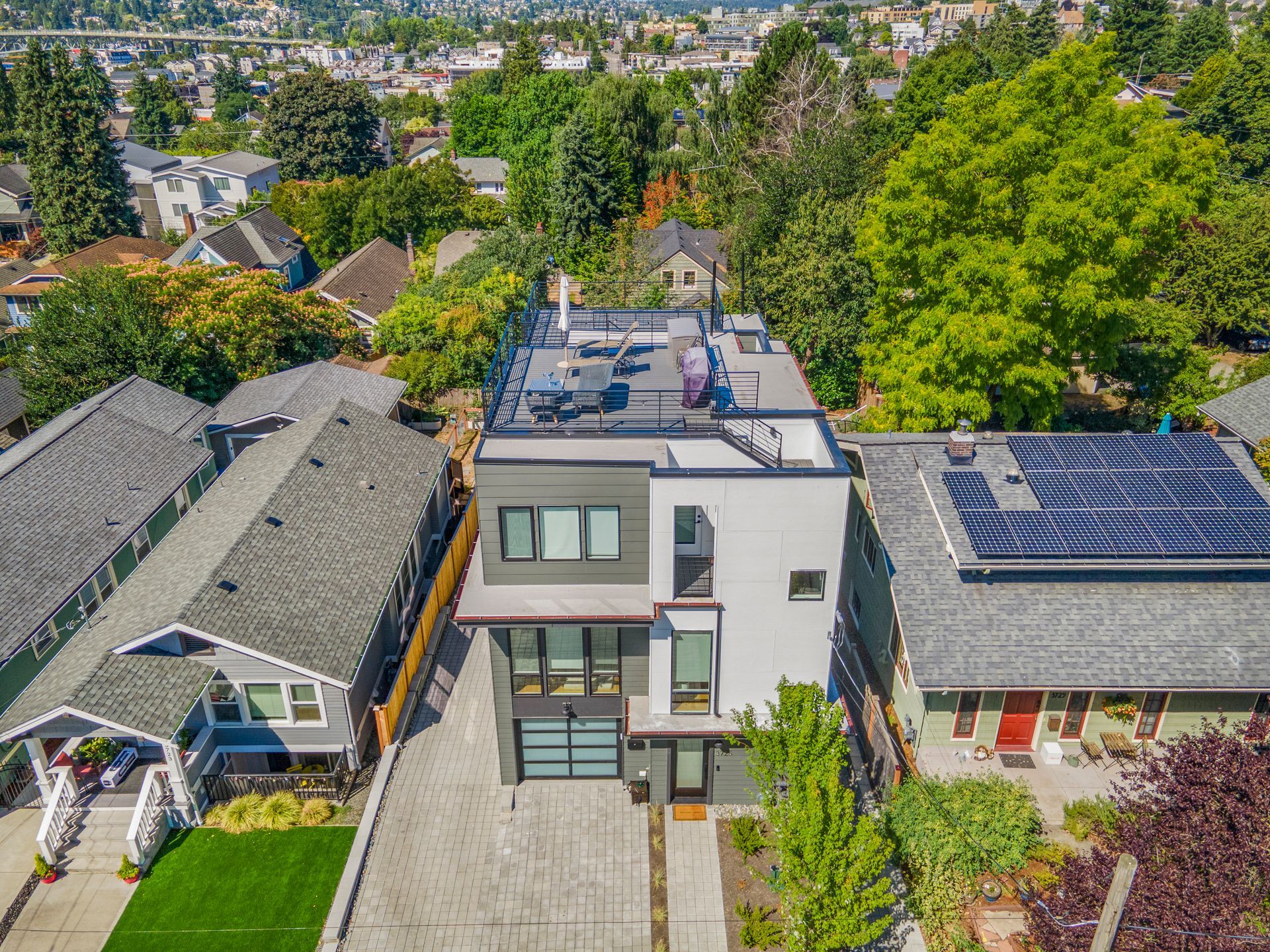 An aerial view of a house with solar panels on the roof.