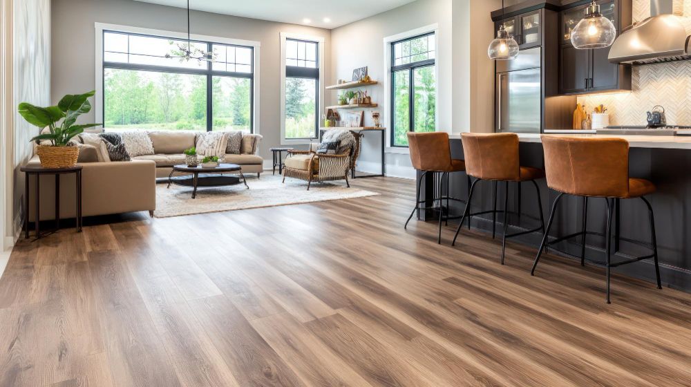 A living room and kitchen in a house with hardwood floors.