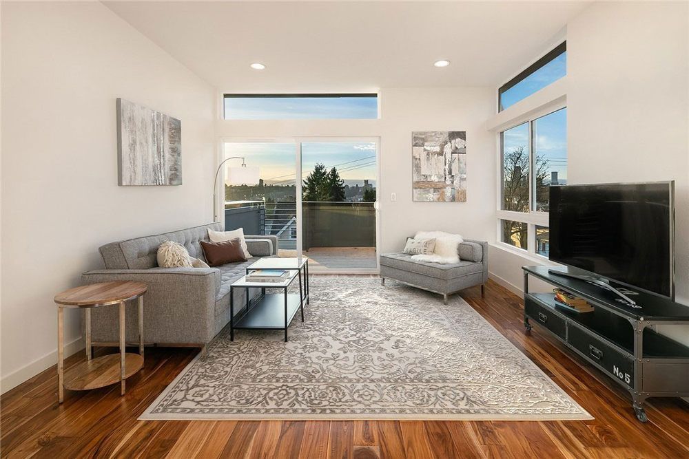 A living room with a couch , chair , table and television.