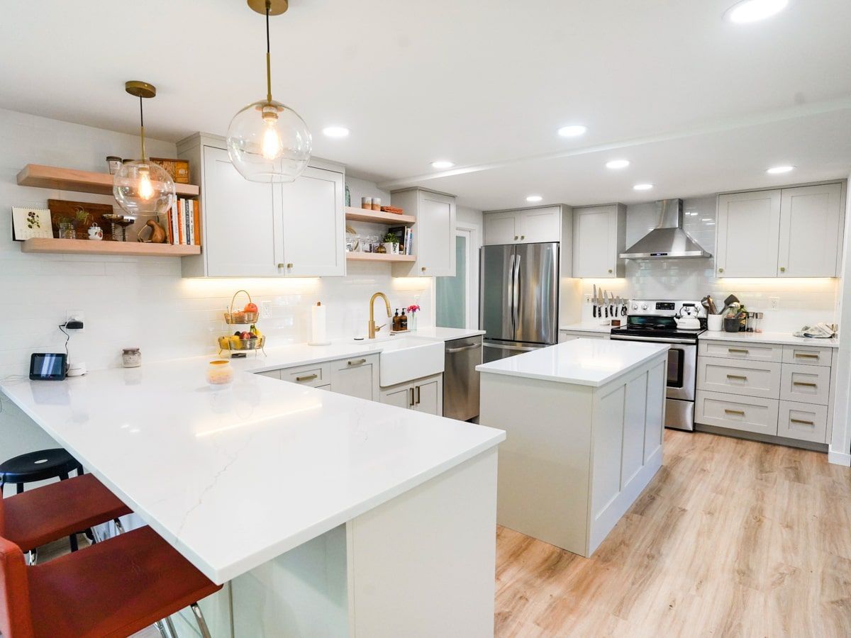 A kitchen with white cabinets and stainless steel appliances